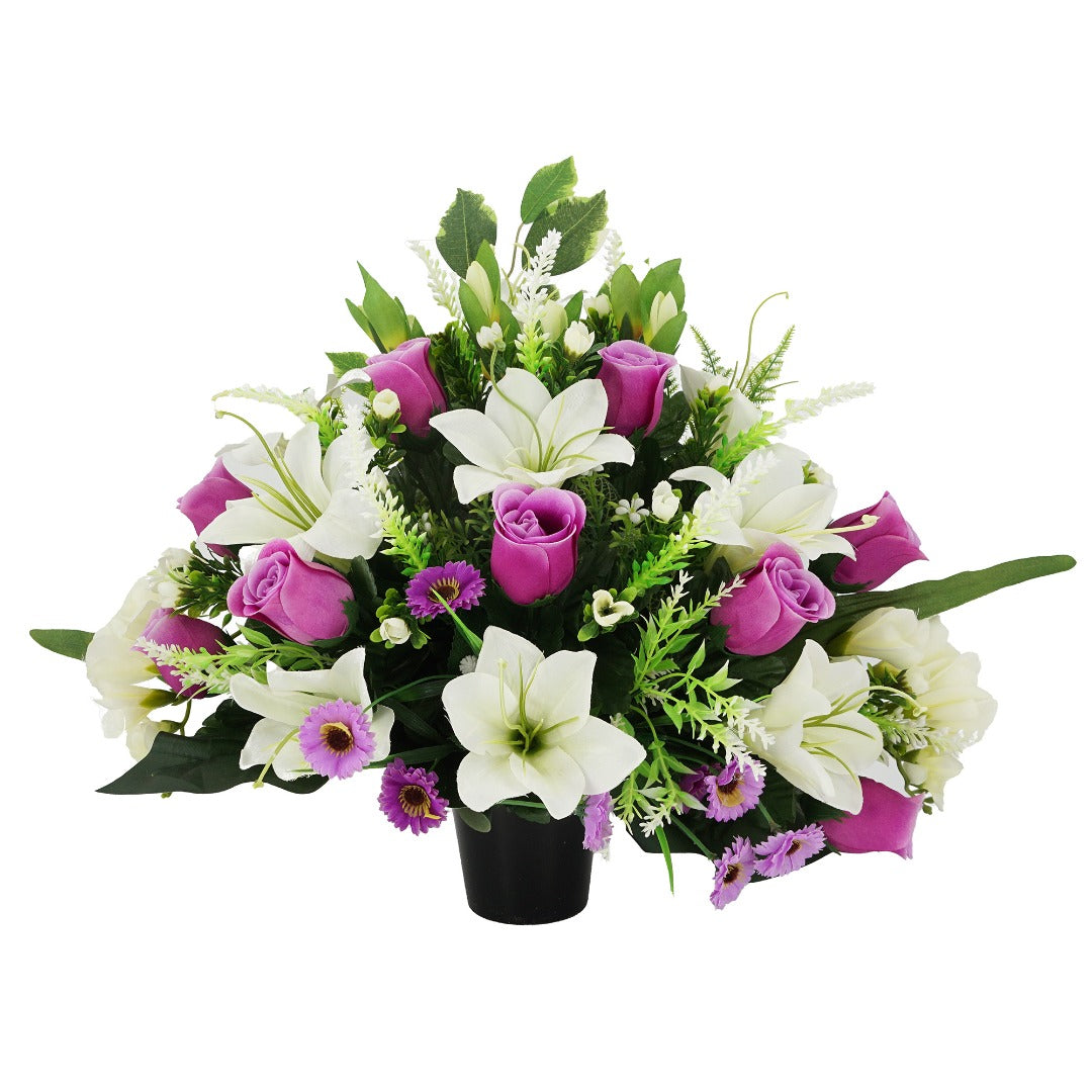 White purple artificial graveside flower arrangement in a pot
