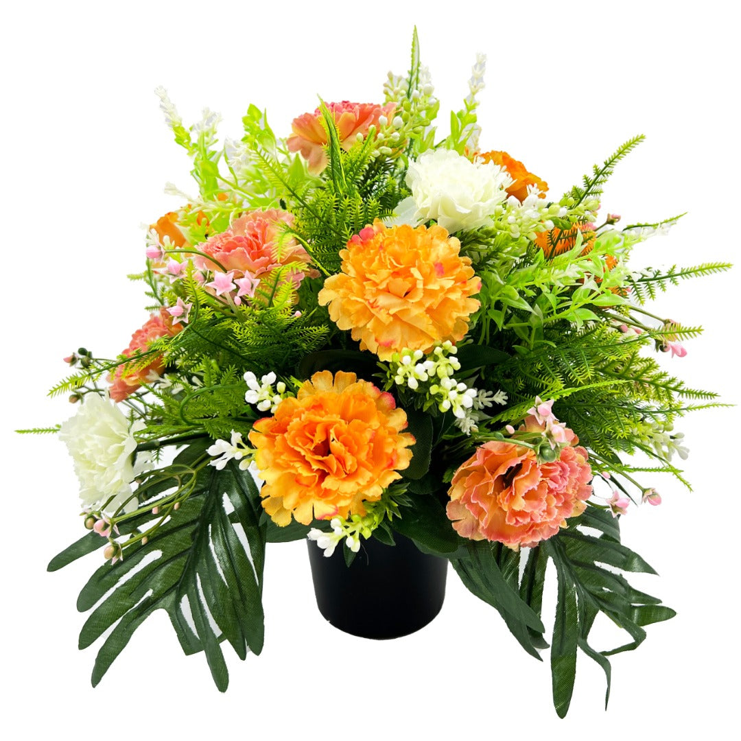 Orange and white artificial graveside flower arrangement in a pot close up
