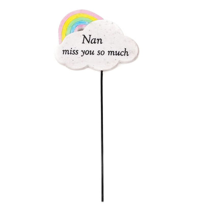 Nan memorial stick with a white cloud plaque reading Nan miss you so much and a pastel rainbow, on a black stake
