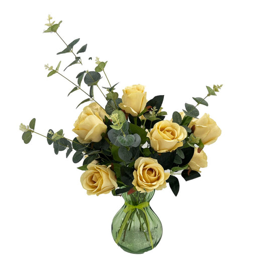 Zinnia yellow silk roses with eucalyptus in green glass vase with clear stones and ribbon