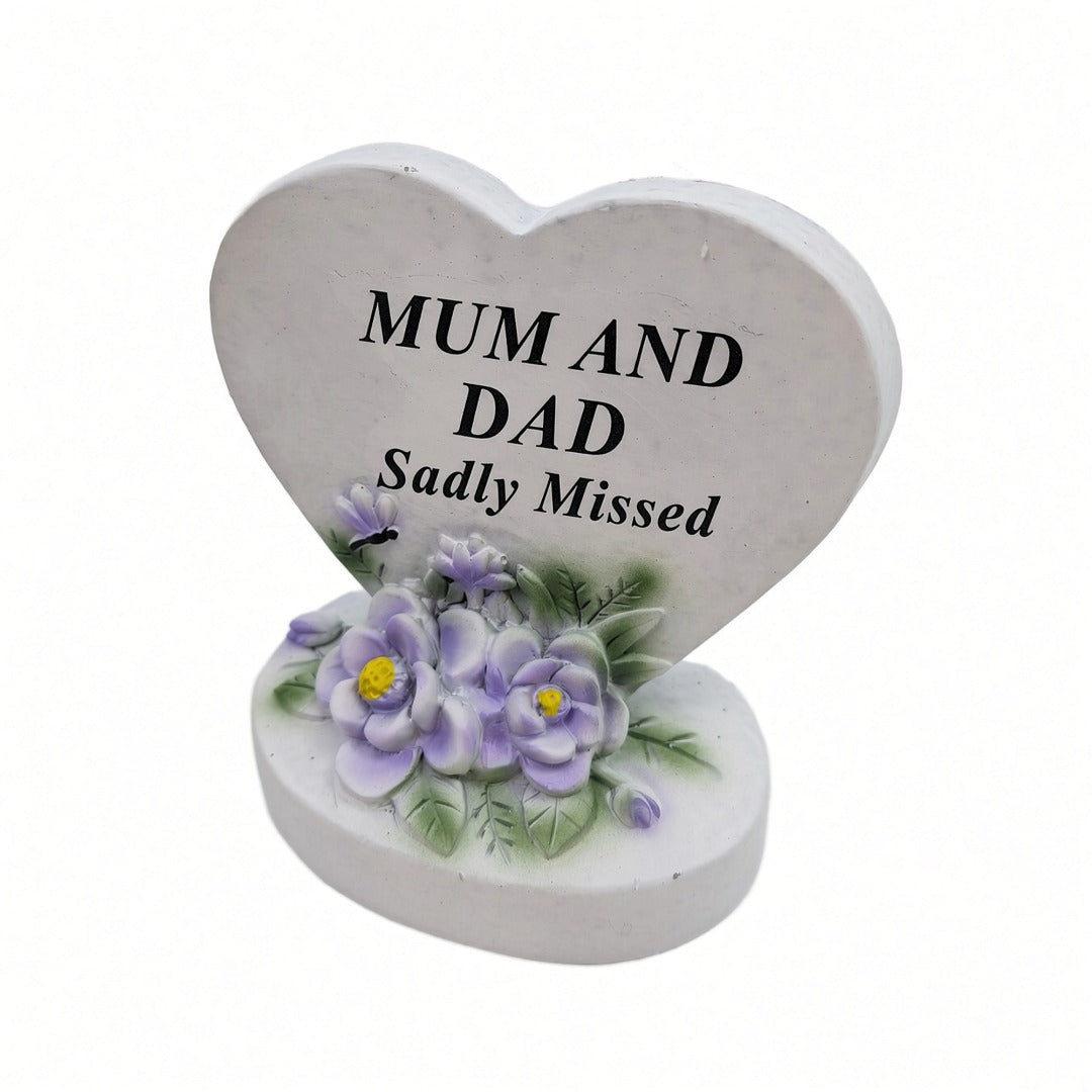 Mum and Dad Sadly Missed white heart memorial with purple flowers close up