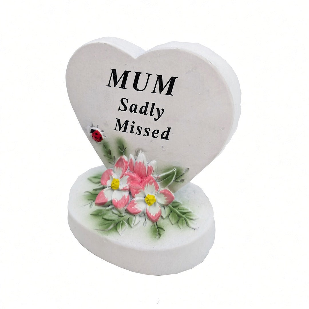 Mum Sadly Missed white heart memorial with pink flowers close up
