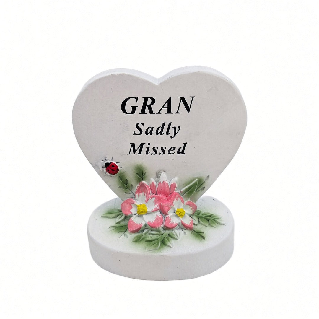 Gran Sadly Missed white heart memorial with pink flowers front view