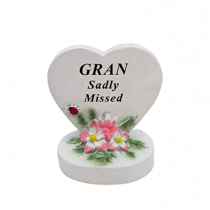 Gran Sadly Missed white heart memorial with pink flowers front view
