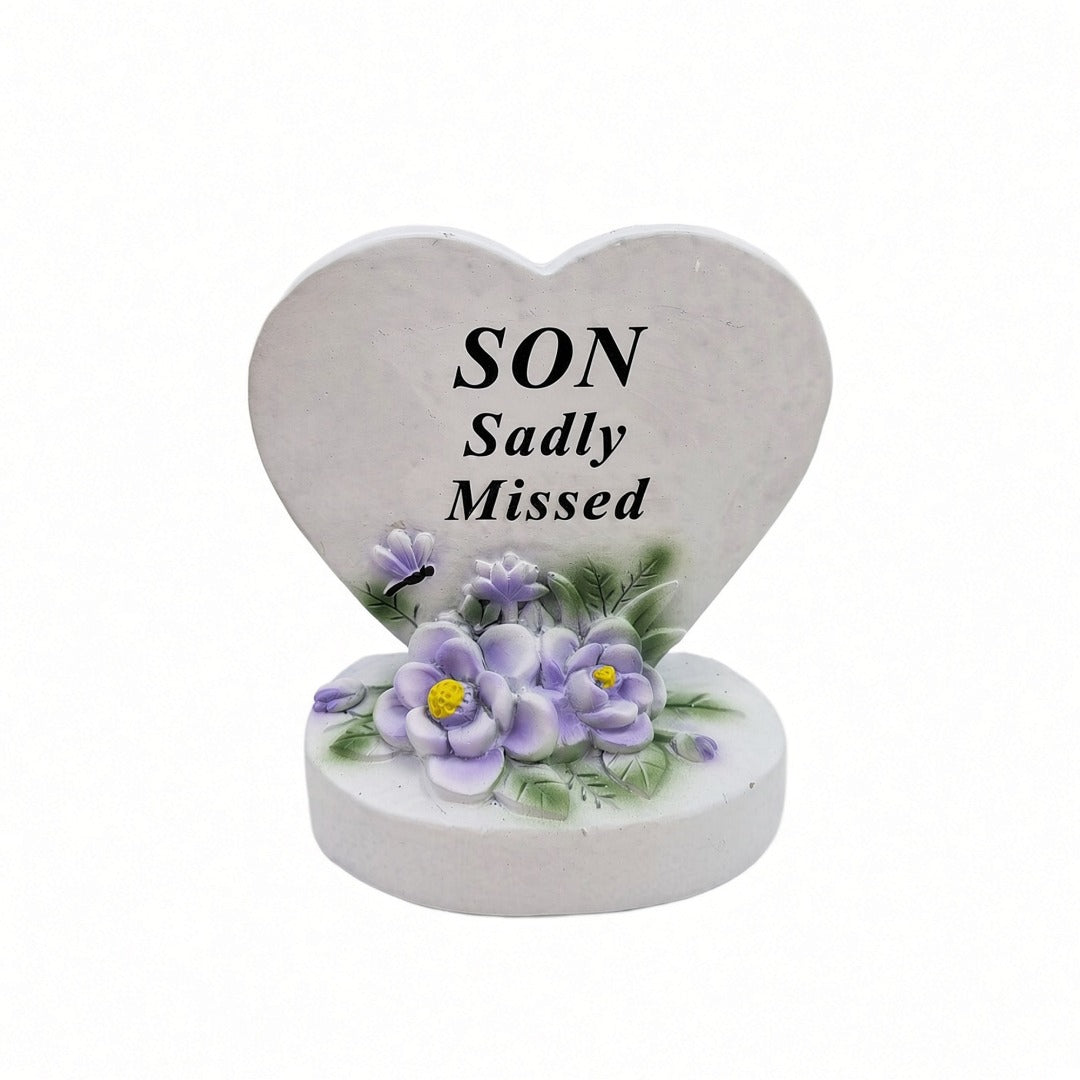 Son Sadly Missed white heart memorial with purple flowers front view