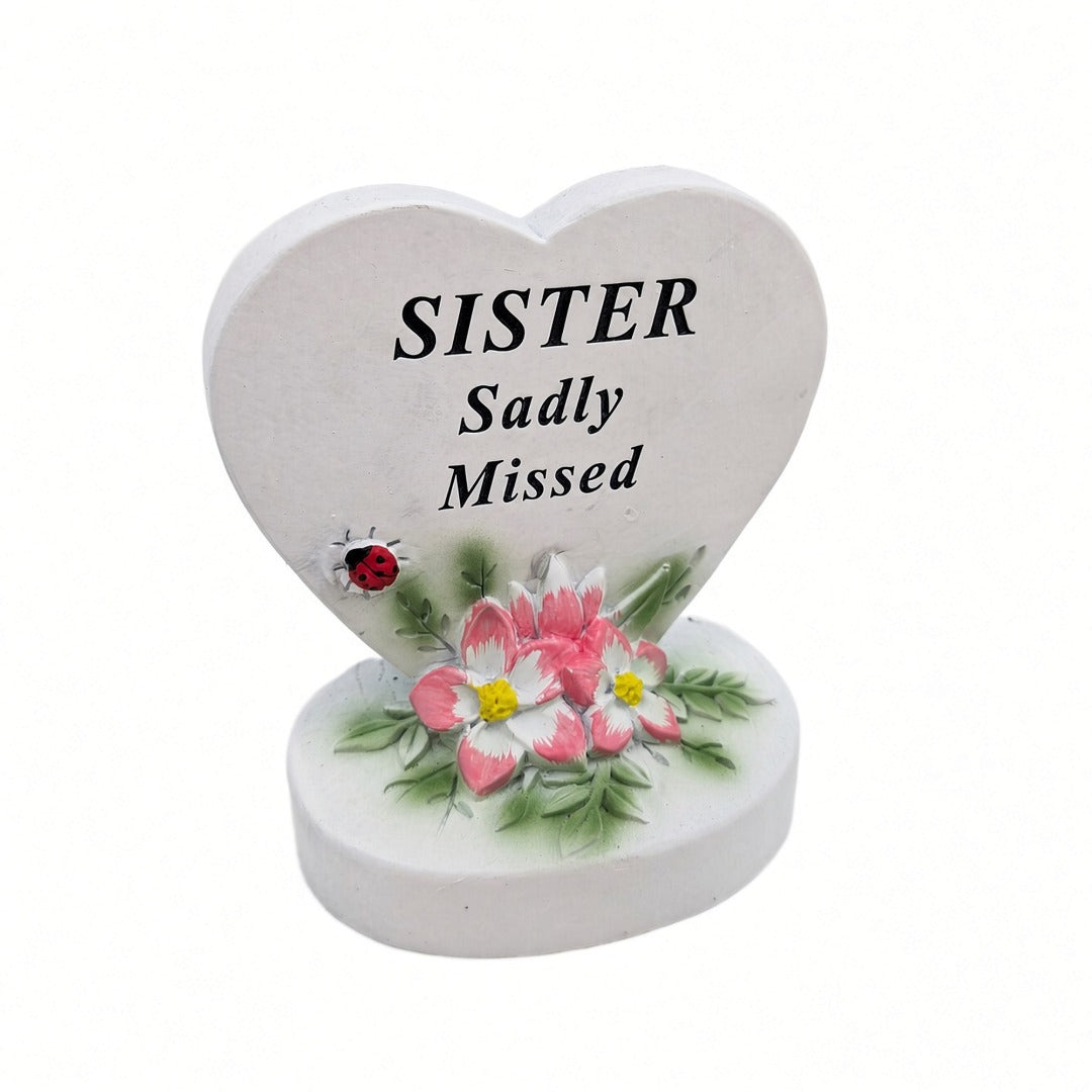 Sister Sadly Missed white heart memorial with pink flowers