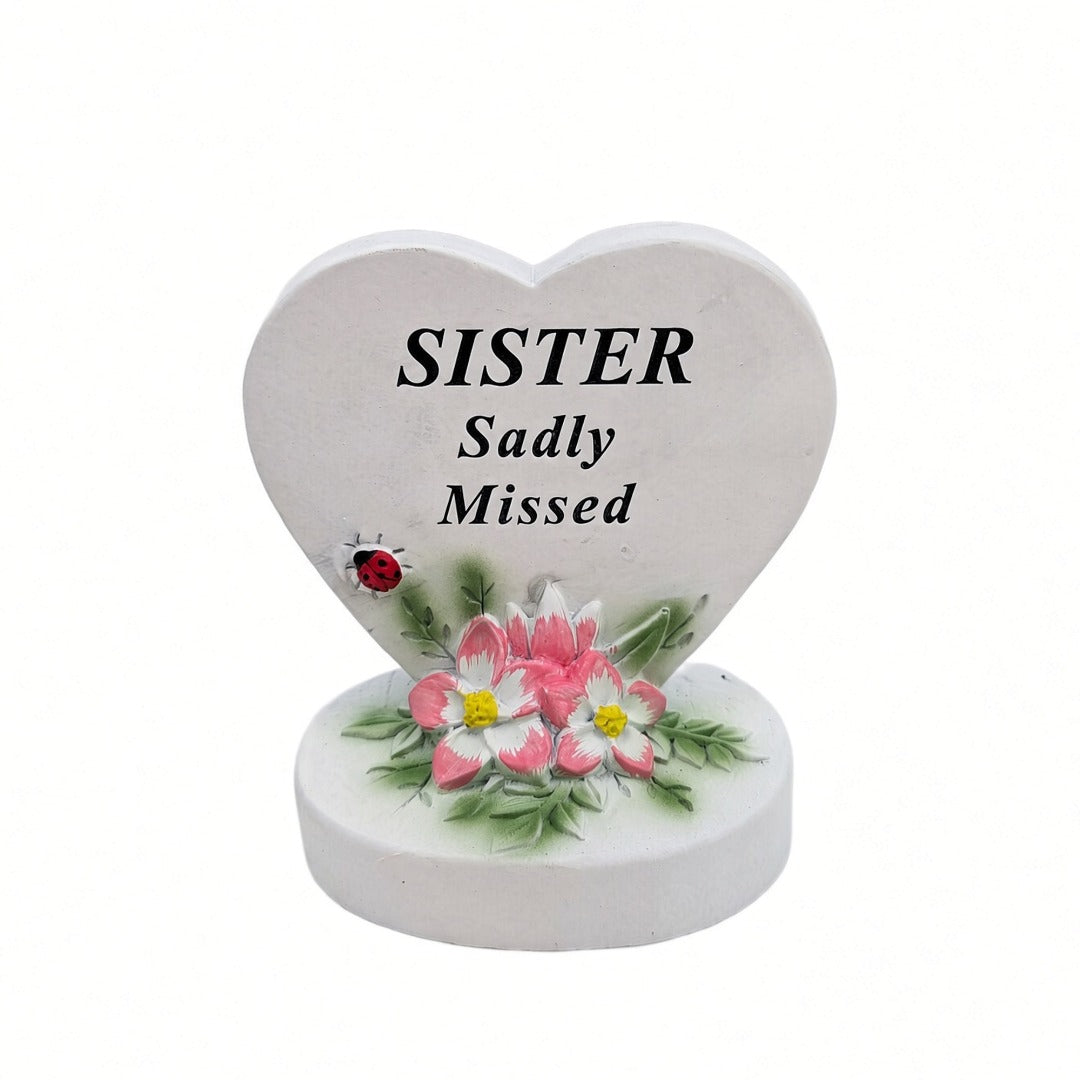 Sister Sadly Missed white heart memorial with pink flowers front view