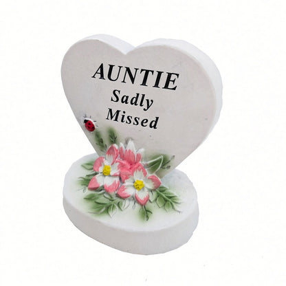 Auntie Sadly Missed white heart memorial with pink flowers close up